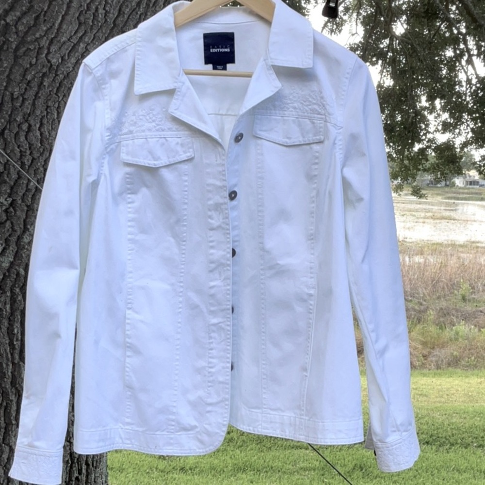 Stylish white denim shirt jacket with embroidered detail.